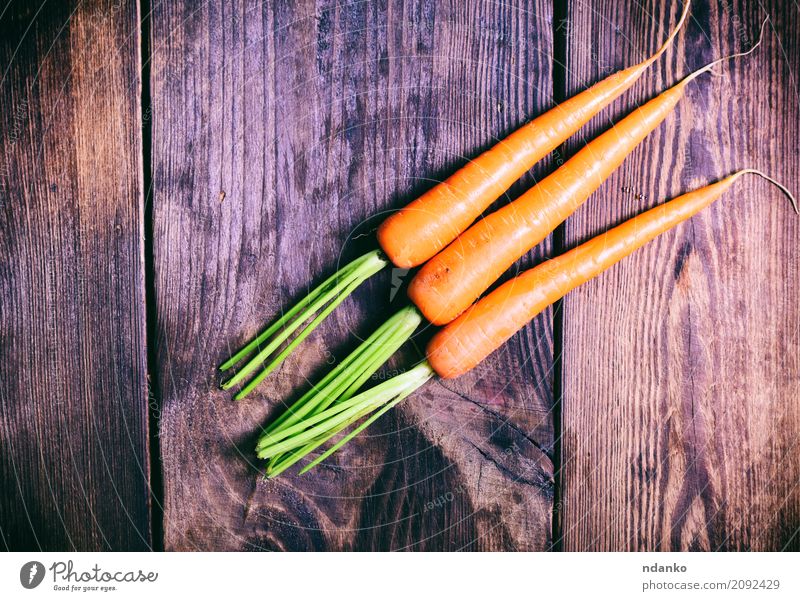 Three fresh carrots Vegetable Nutrition Eating Vegetarian diet Diet Table Nature Plant Wood Fresh Natural Green ripe Useful agriculture Organic orange Salad