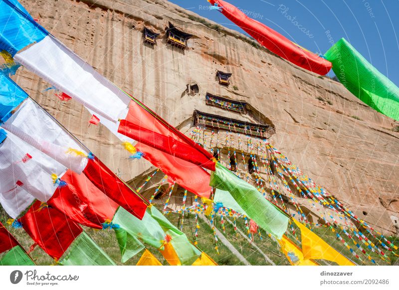 Mati Si temple with colorful praying flags, China Meditation Vacation & Travel Tourism Culture Rock Building Architecture Monument Flag Old Historic Red