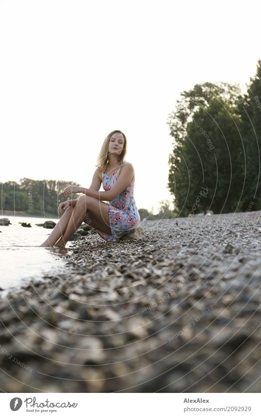 Young woman in summer dress sitting on the banks of the Rhine with her feet in the river Wellness Relaxation Trip Summer Summer vacation Youth (Young adults)
