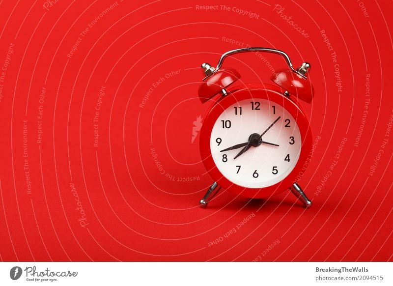 Retro alarm clock with bells over red paper background close up Clock Tool Technology Paper Metal Digits and numbers Old Running Movement Sleep Wait Hot