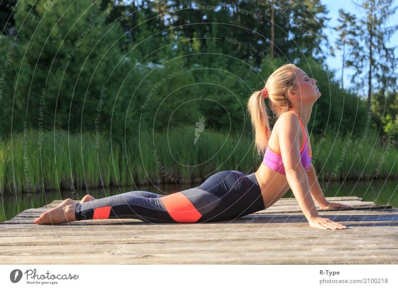 A sporty woman doing yoga and stretching exercises Lifestyle Healthy Wellness Sports Yoga Human being Woman Adults Nature Park Fashion Blonde Fitness aerobics