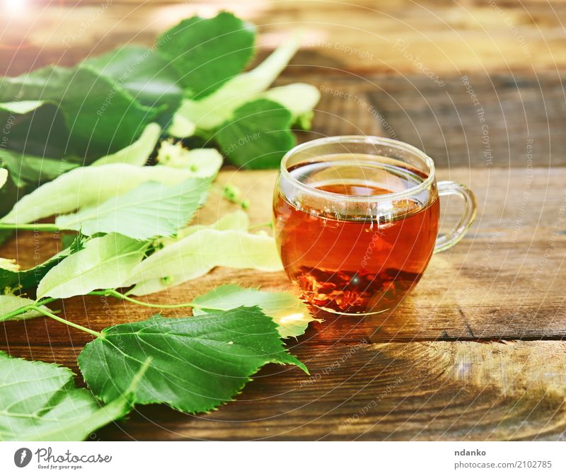 Herbal tea with linden Breakfast Hot drink Tea Cup Mug Table Leaf Wood Fresh Brown Green herbal Transparent branch vintage Useful Tasty sunny Colour photo