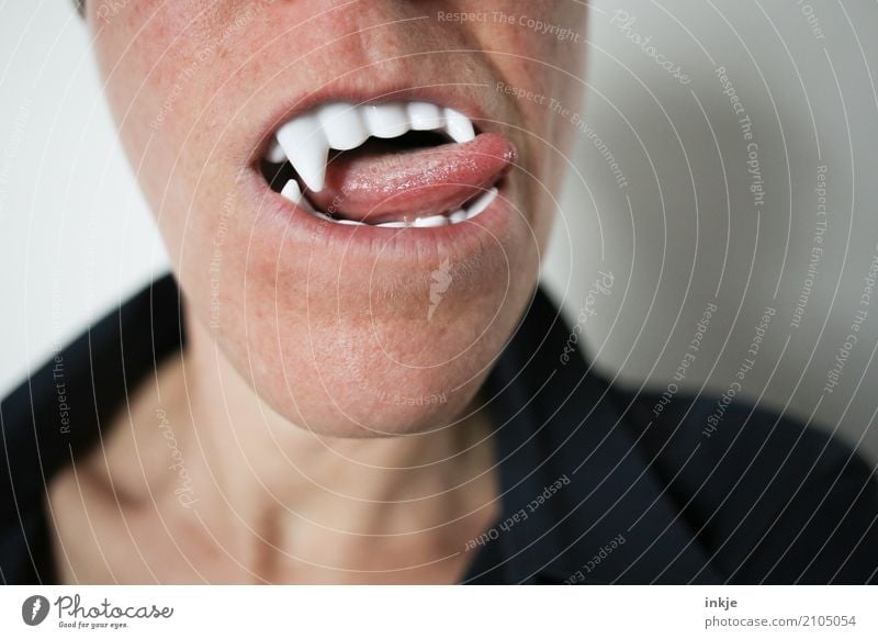 Close-up of a female mouth with vampire teeth and tongue Carnival Hallowe'en Mouth Teeth Tongue 1 Human being To enjoy Threat Desire Thirst Creepy False