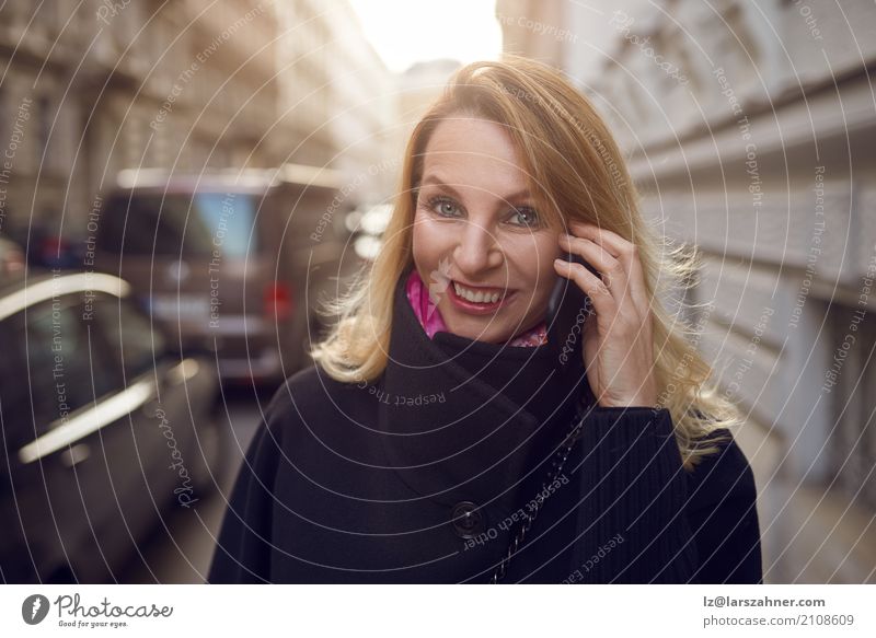 Pretty vivacious woman chatting on a mobile Happy Face Success Business Telephone Technology Woman Adults 1 Human being 30 - 45 years Street Smiling