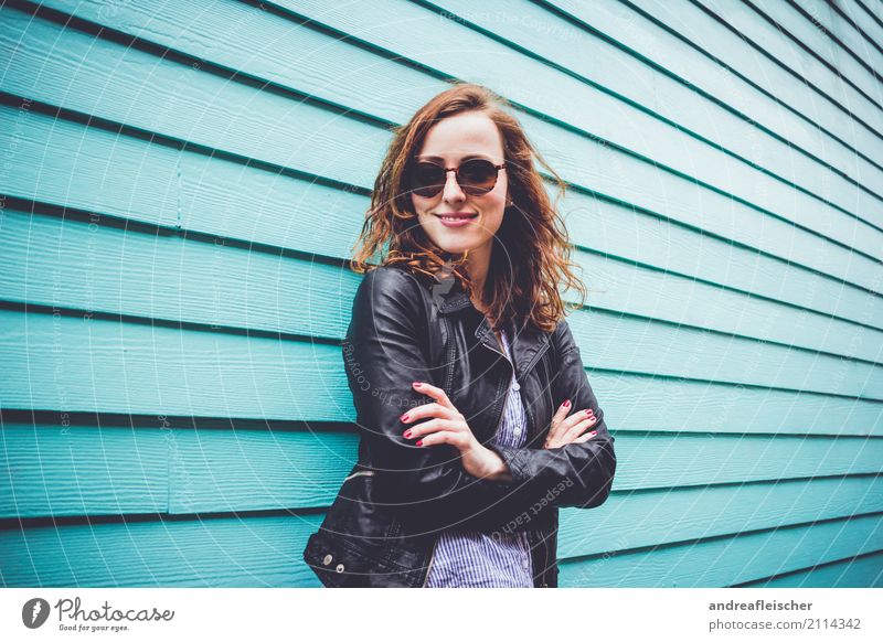 Cool young woman with sunglasses in front of turquoise wooden facade Lifestyle Feminine Young woman Youth (Young adults) 1 Human being 18 - 30 years Adults