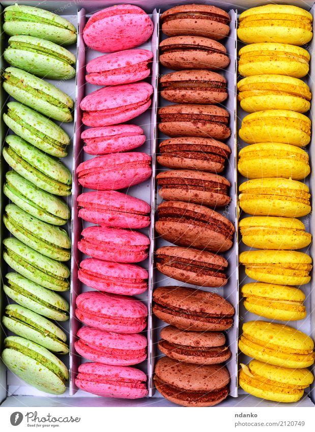 Multicolored macarons in a paper box Dessert Candy Gastronomy Paper Eating Bright Delicious Brown Multicoloured Yellow Green Pink Tradition colorful background