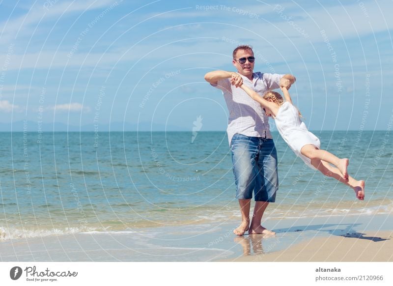 Father and daughter playing on the beach at the day time. Lifestyle Joy Relaxation Leisure and hobbies Playing Vacation & Travel Trip Freedom Summer Sun Beach