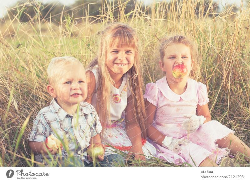 Happy brother and two sisters playing in park at the day time. Apple Lifestyle Joy Beautiful Leisure and hobbies Playing Vacation & Travel Summer Child School