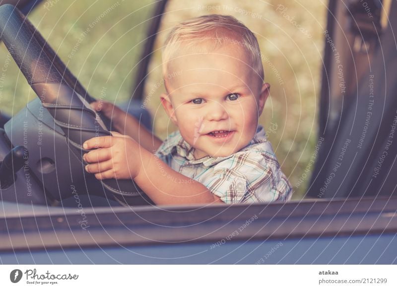 One little boy sitting in the car and look out from the car window at the day time. Concept of happy trip. Lifestyle Joy Happy Beautiful Leisure and hobbies