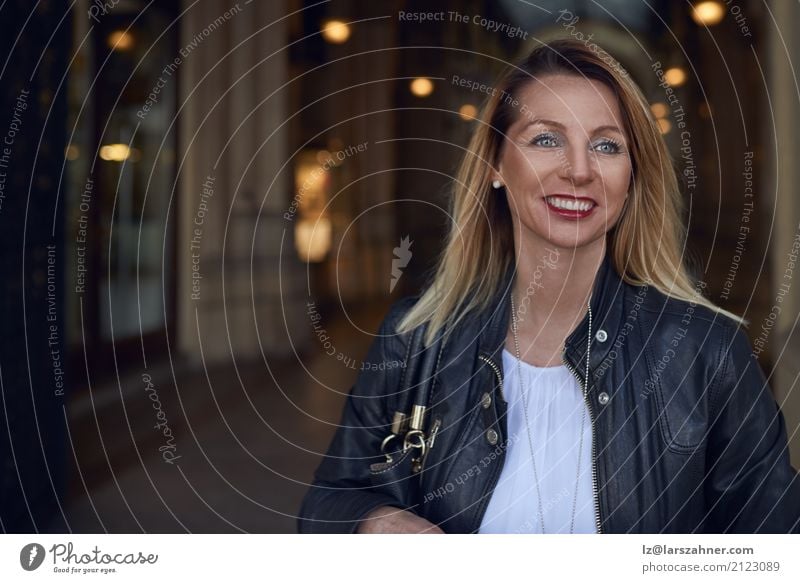 Attractive trendy woman walking through an arcade Happy Summer Woman Adults 1 Human being 30 - 45 years Jacket Sunglasses Blonde Smiling Stand Hip & trendy