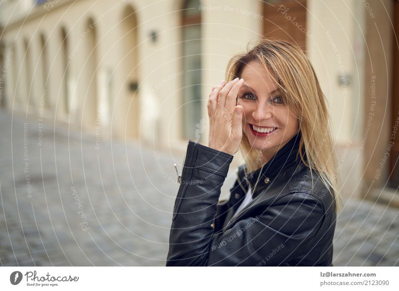 Attractive woman standing outdoors in a courtyard Skin Face Woman Adults 1 Human being 30 - 45 years Pedestrian Street Blonde Smiling Historic Cute attractive
