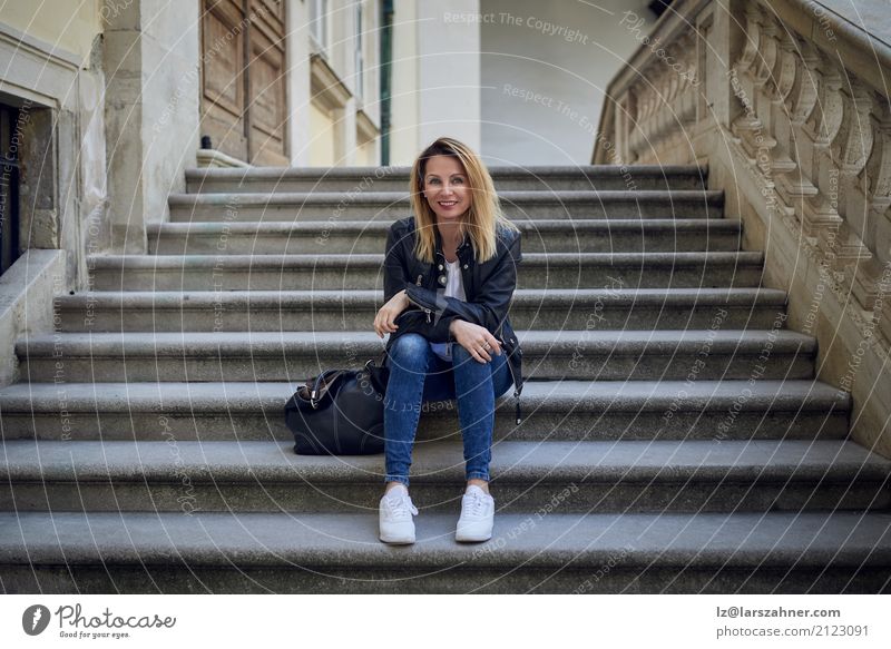 Young smiling woman sitting on steps 1 Human being 30 - 45 years Adults Palace Stairs Smiling Sit Wait Thin young fashionable attractive full body break
