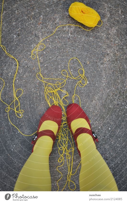 too much thread String unwound Wool Ball of wool Handcrafts be on it Feet Legs Stand Yellow Red Footwear red shoes Asphalt Surrealism