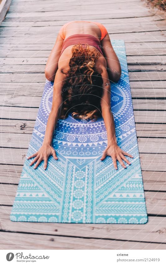 Young woman Doing Stretching Exercises on a yoga mat - a Royalty Free Stock  Photo from Photocase