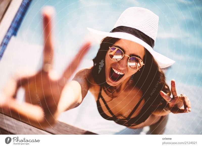 Happy young woman showing peace sign and looking at camera Lifestyle Joy Swimming pool Leisure and hobbies Vacation & Travel Freedom Summer Human being Feminine
