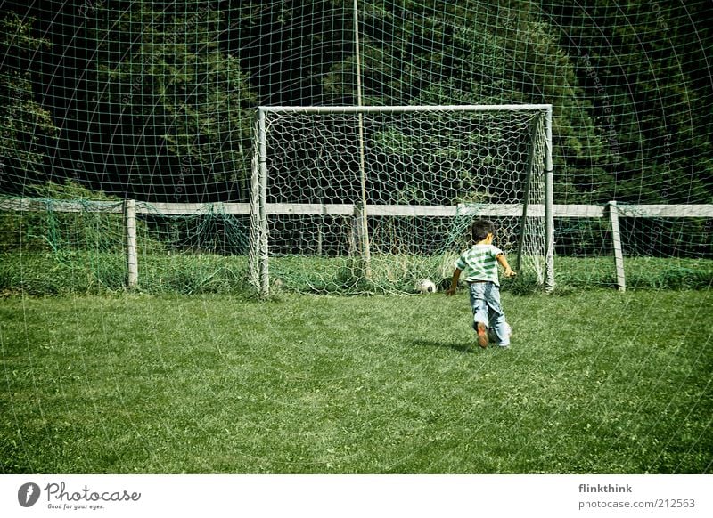 Boy playing football Leisure and hobbies Playing Soccer Vacation & Travel Summer Sports Ball sports Football pitch Human being Masculine Child Boy (child)