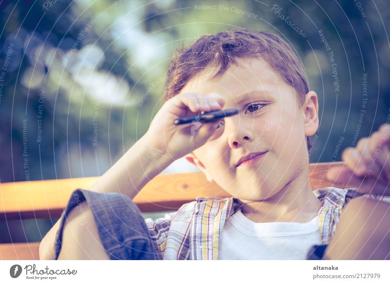 Happy little boy playing in the park at the day time. Lifestyle Joy Beautiful Face Relaxation Leisure and hobbies Playing Summer Child School Human being