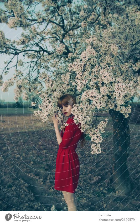 Young woman with red dress posing near a blossoming tree Elegant Style Harmonious Senses Relaxation Calm Fragrance Human being Feminine Youth (Young adults) 1