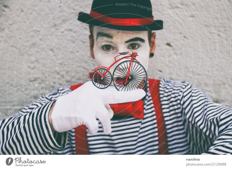 Young man with a clown costume is holding a little bike Style Feasts & Celebrations Carnival Hallowe'en Bicycle Human being Masculine Youth (Young adults) 1