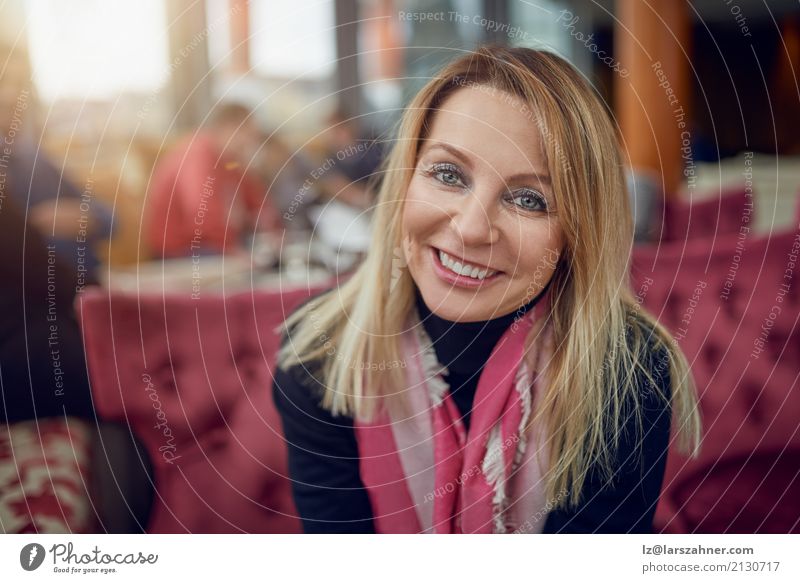 Attractive woman sitting in a restaurant Happy Restaurant Business PDA Woman Adults Fashion Scarf Blonde Smiling Sit Thin attractive Middle-aged best ager