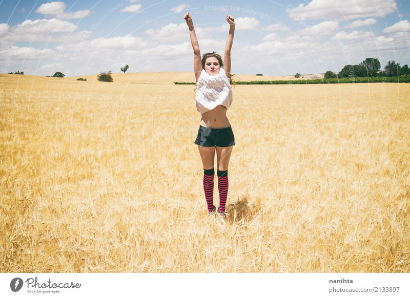 Young woman jumping in a field of wheat Lifestyle Joy Wellness Vacation & Travel Summer Summer vacation Sun Success Human being Feminine Youth (Young adults) 1