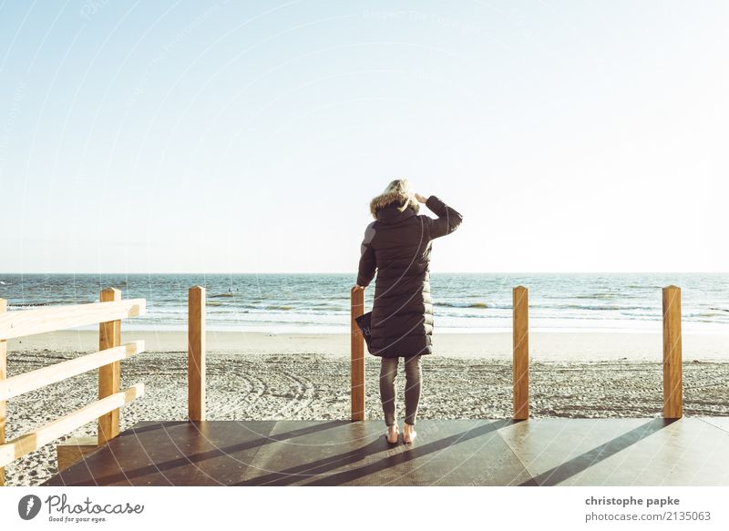 Woman standing by the sea Adults 1 Human being Sky Cloudless sky Spring Beautiful weather Waves coast Beach North Sea Ocean Jacket Coat Looking Far-off places