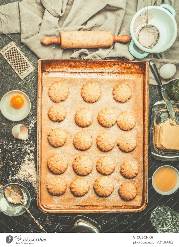 Biscuits on baking tray with ingredients and dough roller Food Dough Baked goods Cake Dessert Nutrition Crockery Style Design Winter Living or residing Table