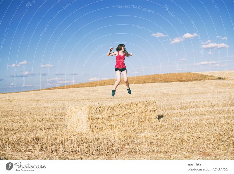Young woman jumping in a field of harvest wheat Lifestyle Joy Wellness Vacation & Travel Adventure Freedom Summer Summer vacation Human being Feminine