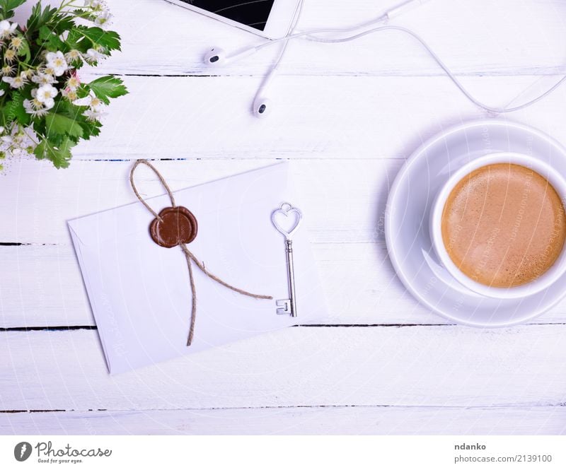 Cup of coffee Breakfast To have a coffee Hot drink Coffee Mug Telephone PDA Flower Blossoming Eating Above envelope seal key Bud Top cup Headphones Colour photo