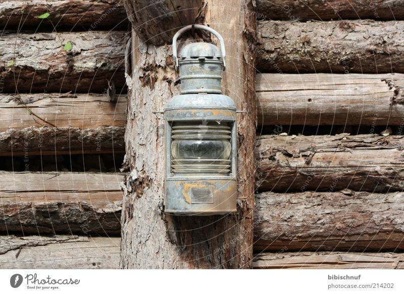 old rusty lantern at the wooden fence Wood Brown Colour photo Exterior shot Deserted Day Front view Lantern ship's lantern Wooden wall Joist Gray Old Shabby