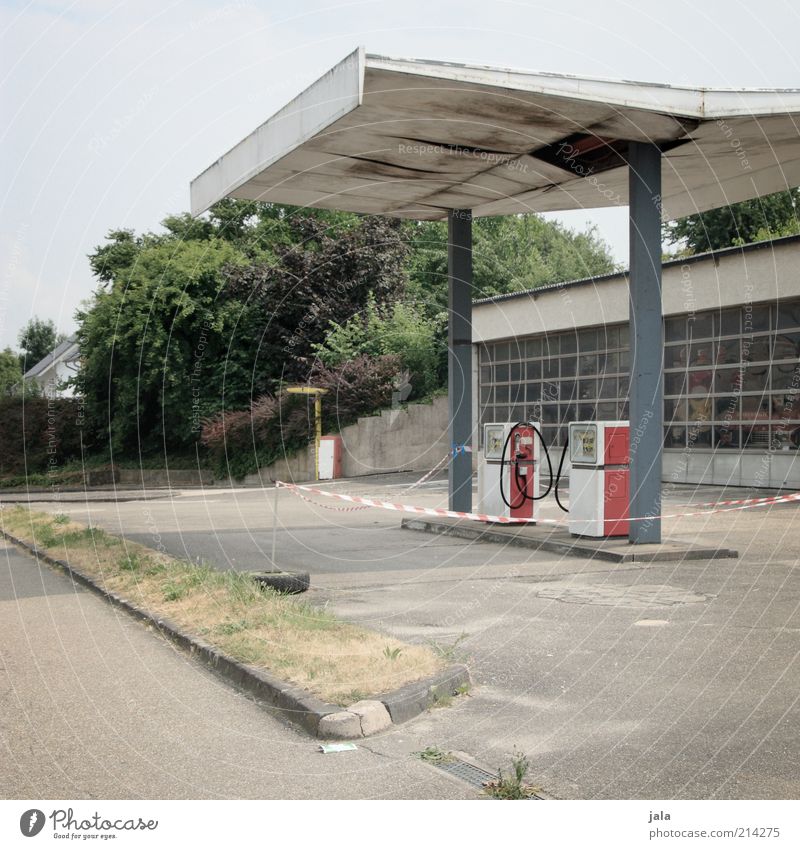 everything super! Sky Tree Bushes Industrial plant Manmade structures Building Architecture Old Esthetic Petrol station Petrol pump Colour photo Exterior shot