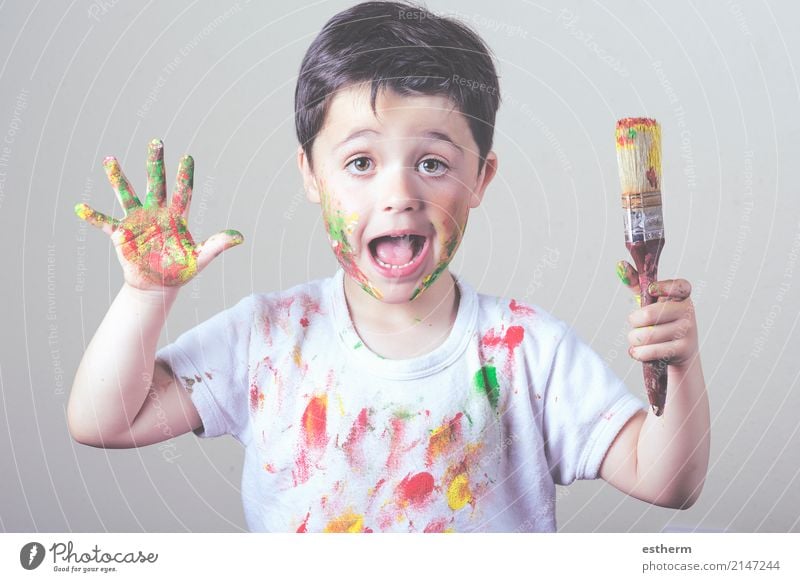 boy with painted face and T-shirt painting Lifestyle Joy Children's game Education Kindergarten School Human being Masculine Toddler Infancy 1 3 - 8 years