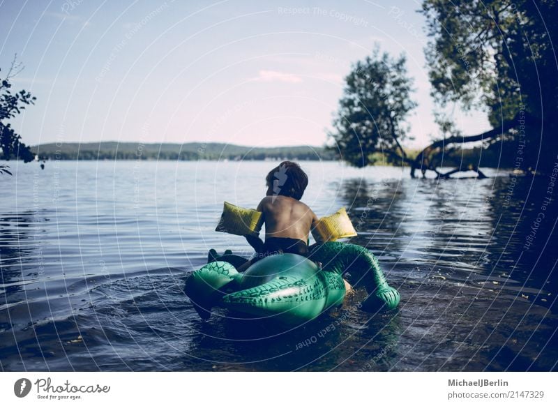 Boy on plastic swimming aid in the lake Playing Float in the water Summer Beach Lake Lakeside Masculine Child Infancy 1 Human being 3 - 8 years Environment