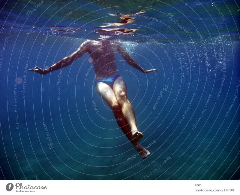 Underwater shot of a swimming man Lifestyle Happy pretty Harmonious Swimming & Bathing Vacation & Travel Summer Summer vacation Ocean Waves Sportsperson Dive
