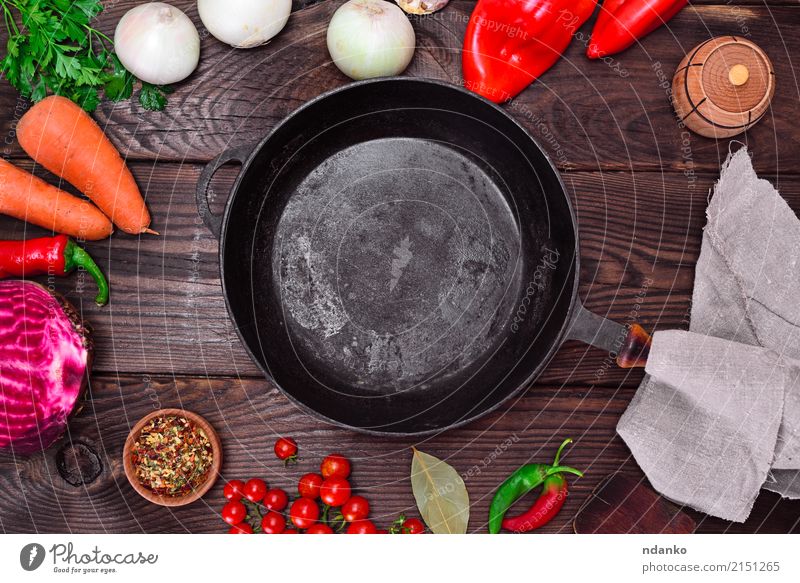 Empty black cast-iron frying pan Vegetable Herbs and spices Pan Wood Metal Eating Fresh Red Black empty Cast iron food cook cooking ripe Red beet Tomato Carrot
