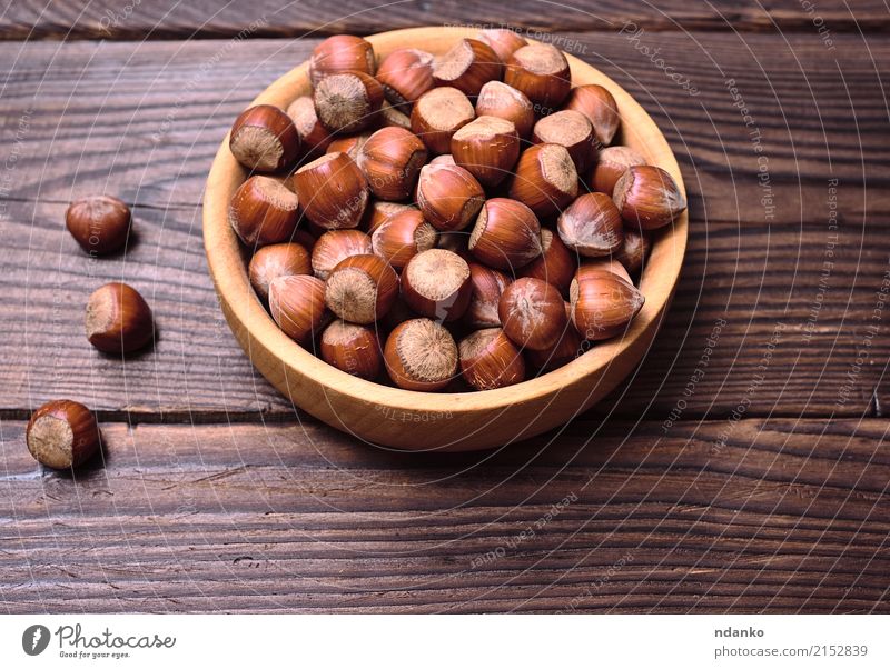Hazelnuts in a shell Fruit Nutrition Vegetarian diet Plate Bowl Table Nature Autumn Wood Old Fresh Natural Above Strong Brown background dry eat Edible food