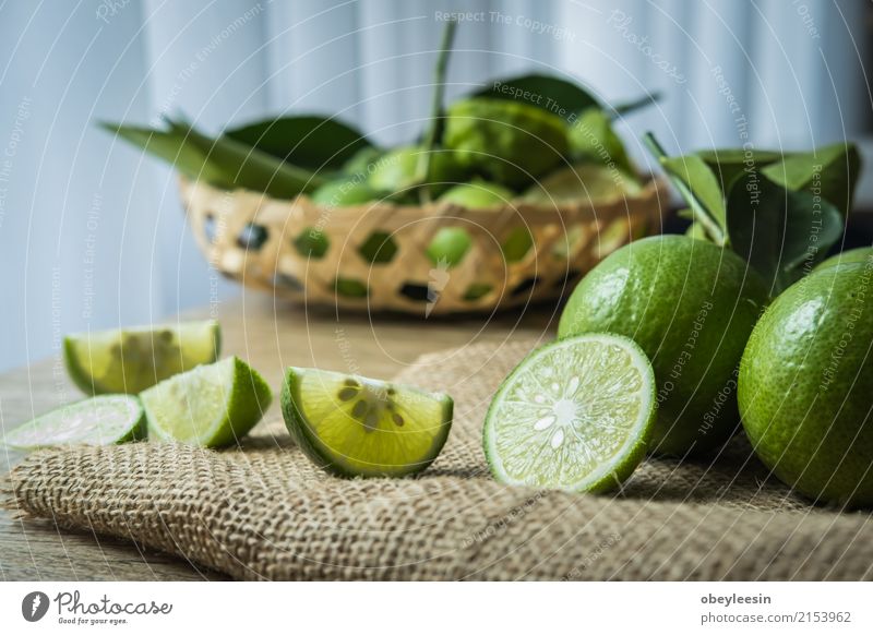 Backgrounds. Close up shot of wet limes Fruit Vegetarian diet Lemonade Group Fresh Juicy Sour Green White ripe isolated Half Part Slice two background Sliced