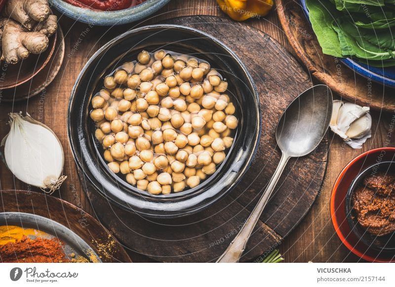 Cooked chickpeas in peel with spoon and cooking ingredients Food Grain Herbs and spices Cooking oil Nutrition Lunch Dinner Organic produce Vegetarian diet Diet
