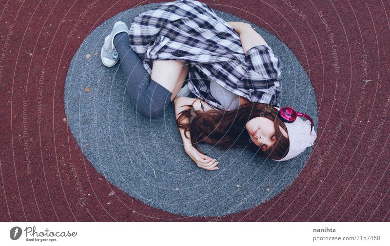 Young woman listening to music is lying down on the floor Lifestyle Style Relaxation Human being Feminine Youth (Young adults) 1 18 - 30 years Adults Music