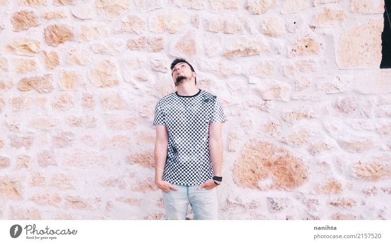 Young man posing with a stone wall as background Lifestyle Style Human being Masculine Youth (Young adults) 1 18 - 30 years Adults Youth culture Clothing