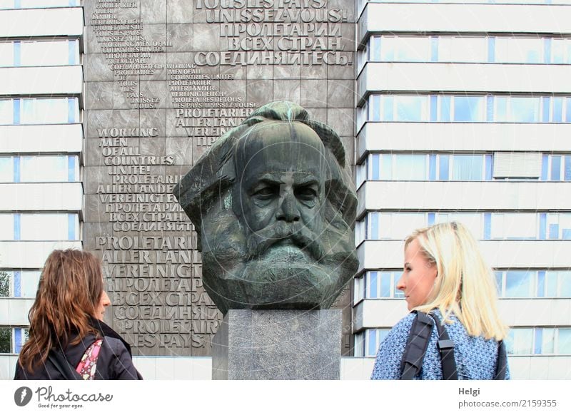two women, one brunette, the other blond, stand in half profile in front of the Karl Marx monument in Chemnitz Human being Feminine Woman Adults 2 30 - 45 years
