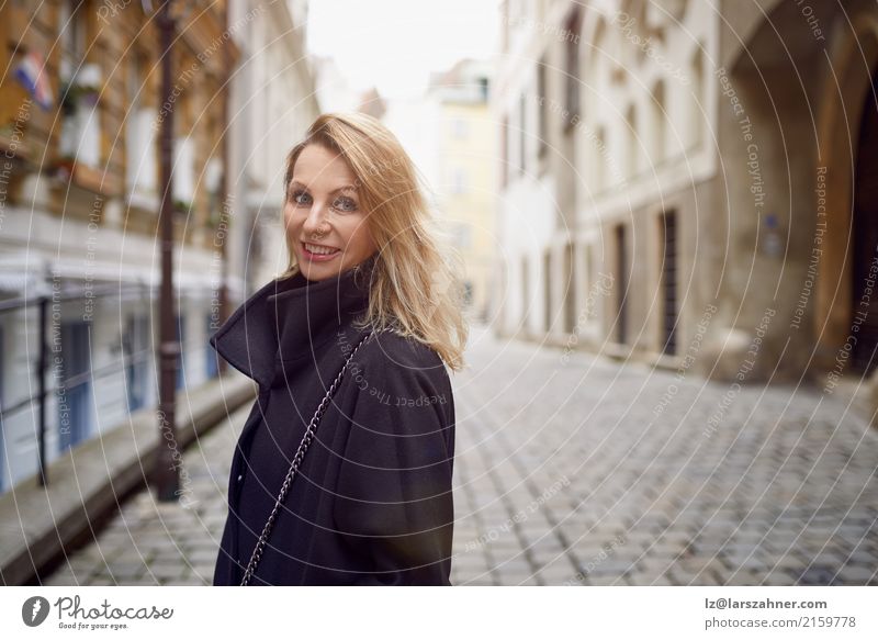 Attractive woman standing outdoors in a courtyard Skin Face Woman Adults 1 Human being 30 - 45 years Pedestrian Street Blonde Smiling Historic Cute attractive