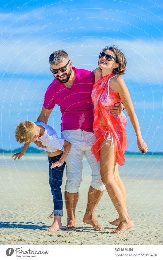 Happy family of three at the tropical beach, laughing and enjoying time together. Lifestyle Joy Playing Summer Ocean Island Infancy Landscape Sunglasses Beard