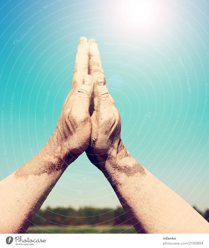 two male hands stacked togethe Sun Hand Sky Bright Blue Religion and faith Prayer Heaven Gesture up sunny part Colour photo