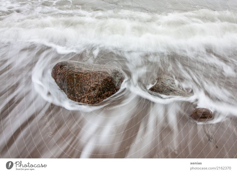 Stones in the surf Tourism Beach Ocean Waves Environment Nature Climate change Coast North Sea Baltic Sea Surf Cold Maritime Brown White Flow Rock Colour photo