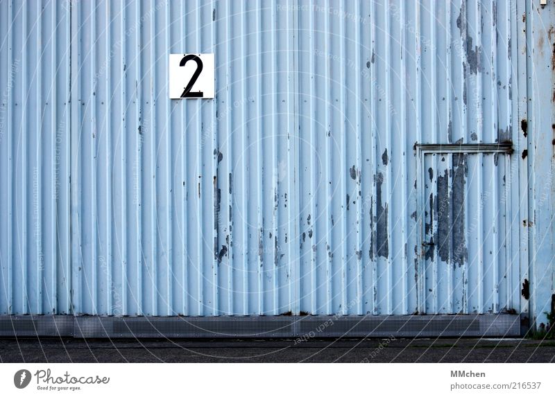Gate number 2 Building Blue Warehouse Hall Tin Door Entrance Signs and labeling signage Digits and numbers Gray Hangar Colour photo Exterior shot Deserted