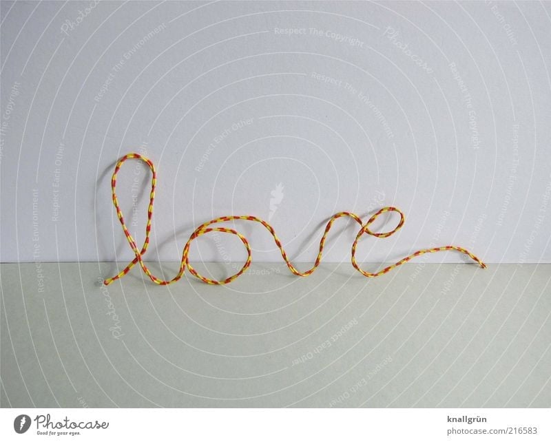 Pretty wiry. Wire Characters Love Yellow Gray Red White Emotions Infatuation Relationship Calligraphy Curved Striped Colour photo Studio shot Deserted