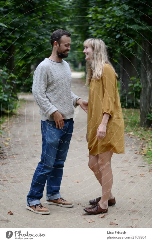 Young smiling couple on a path in the park. Couple Partner Life 2 Human being 18 - 30 years Youth (Young adults) Adults Environment Summer Park Jeans Dress