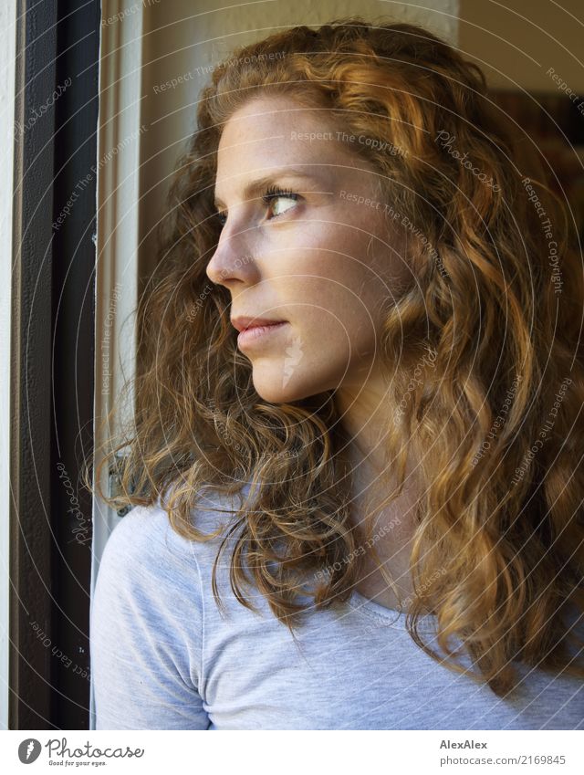 young, redheaded woman with curls looks out of the balcony window Style already Face Life Young woman Youth (Young adults) Hair and hairstyles 18 - 30 years