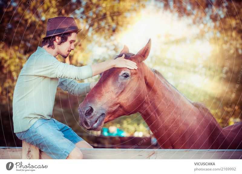 Horse and young man with hat Lifestyle Winter Human being Young man Youth (Young adults) Nature Beautiful weather Emotions Design Sentimental Communicate